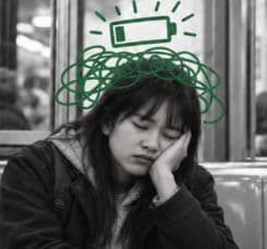 Lucy resting her head on her hand, with an illustrated empty battery above her