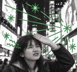 Lucy shielding her eyes from the bright lights, with green light illustrations
