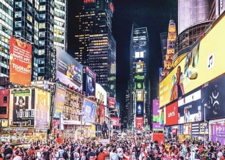 Bright advertising screens and crowds in Times Square at night